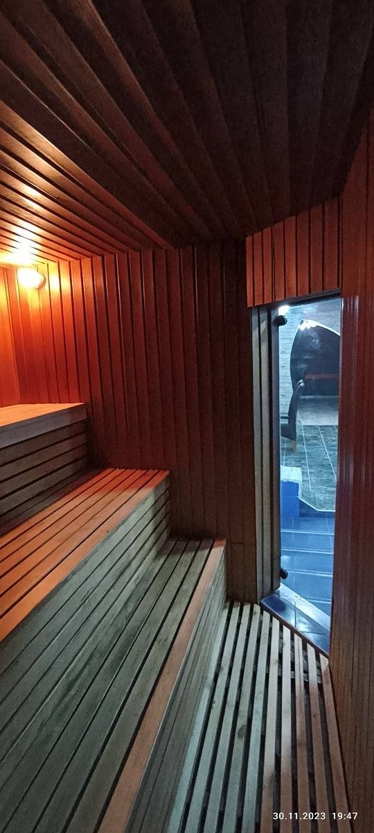 Modern sauna interior with wooden benches and warm ambient lighting