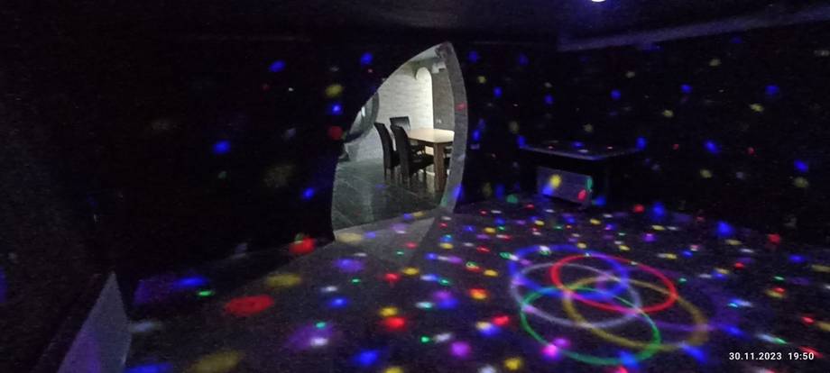 Laser tag arena with glowing floor patterns and active player in pod