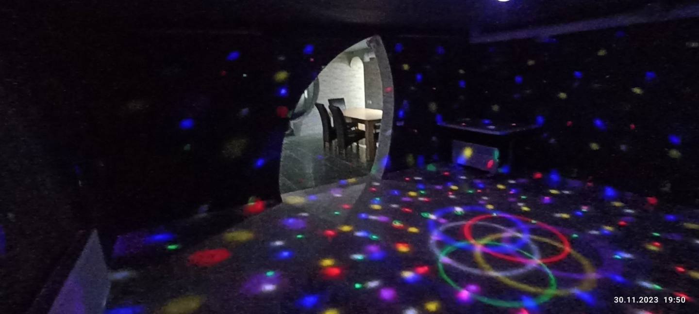 Laser tag arena with glowing floor patterns and active player in pod