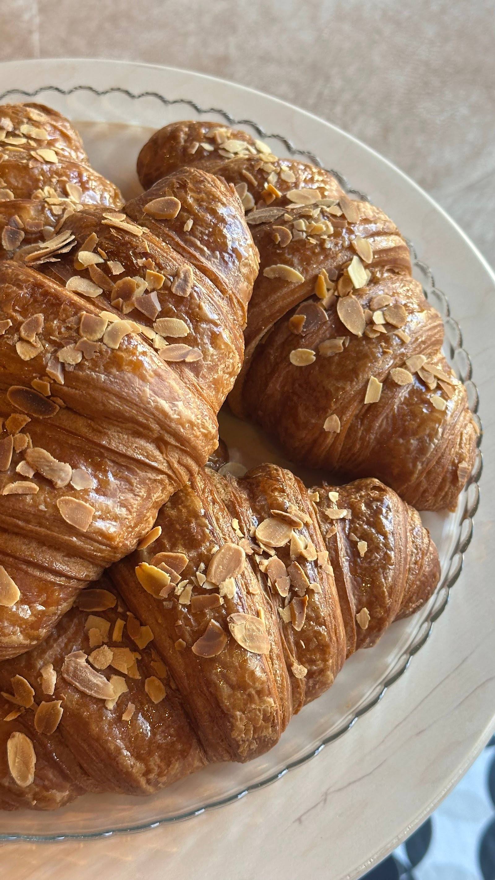 Almond croissants on white decorative plate