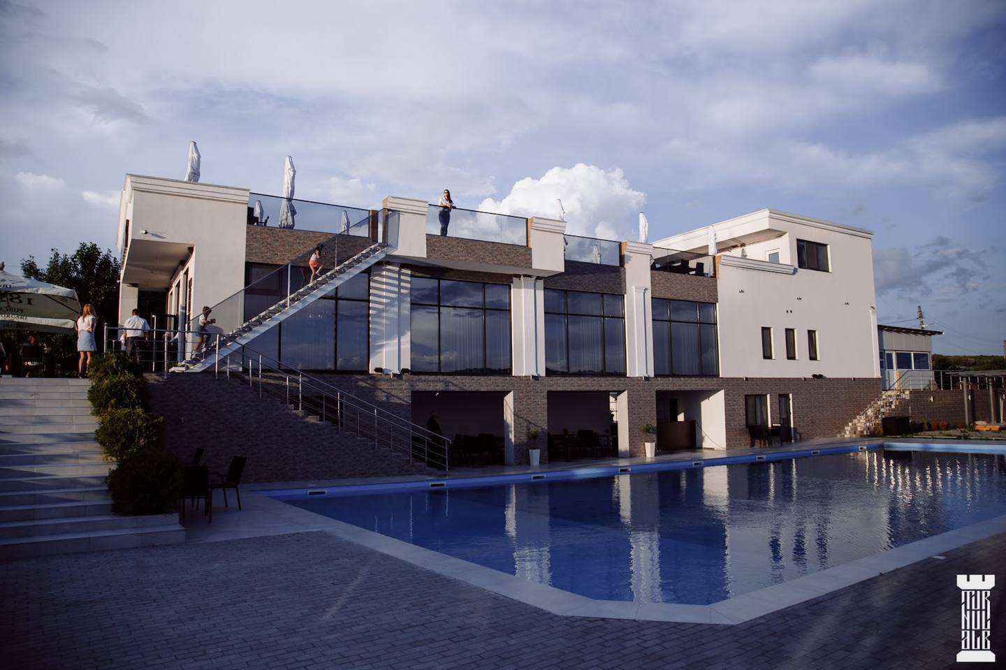 Modern spa or wellness resort exterior with reflecting pool and contemporary architecture