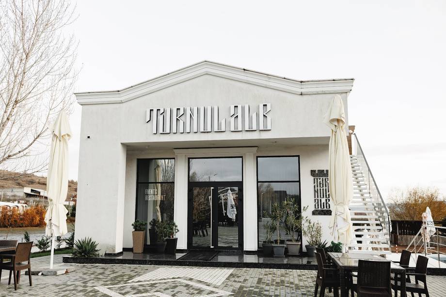 Minimalist white storefront with modern signage and glass frontage