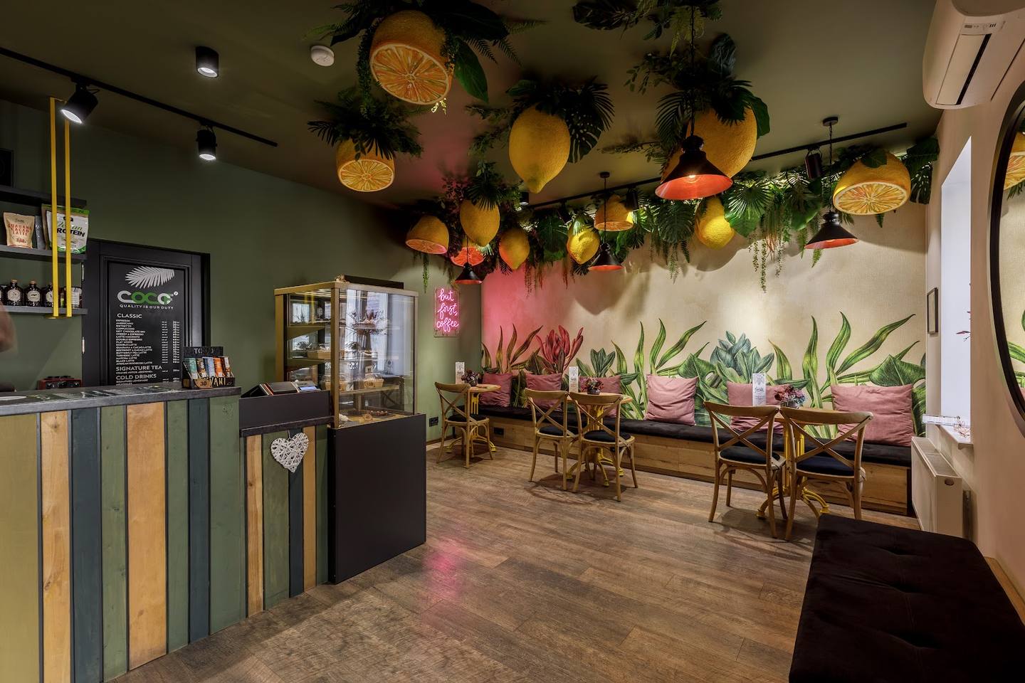 Modern cafe interior with botanical decor, ambient lighting, and seating area