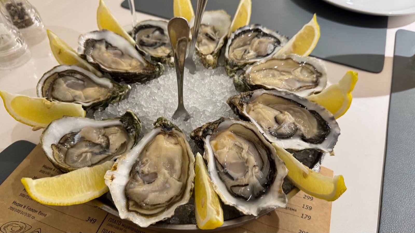 Fresh oysters arranged with lemon wedges on crushed ice