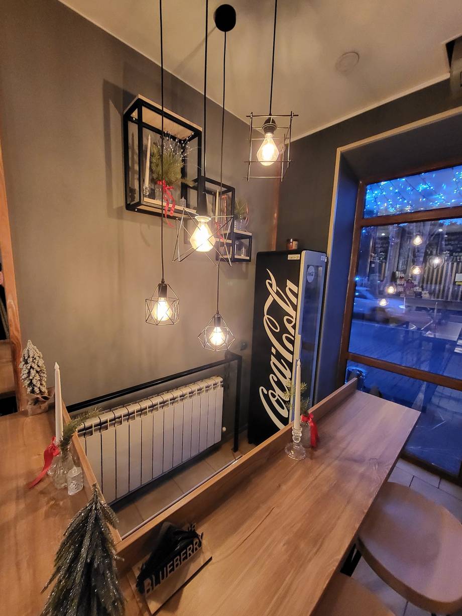 Modern cafe interior with pendant lighting and street-view window seating
