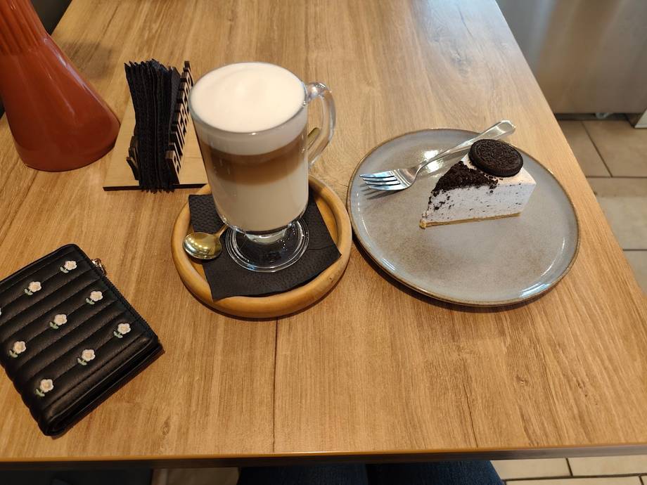 Cappuccino with dessert plate on wooden table service