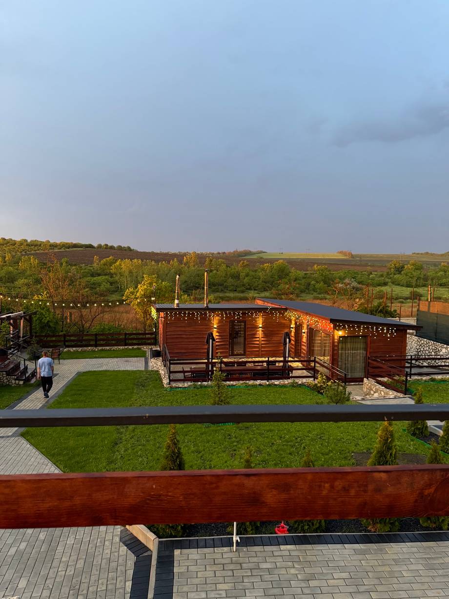 Wooden pavilion and landscaped grounds overlooking Moldova countryside