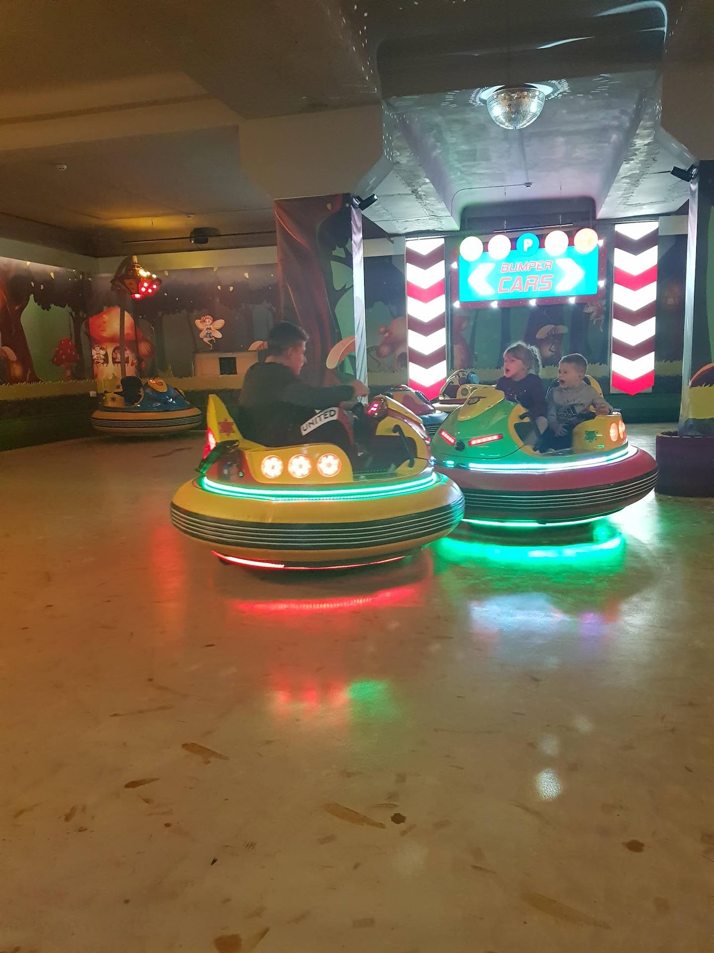 Children's bumper car rides with LED lighting and arcade games in indoor play center
