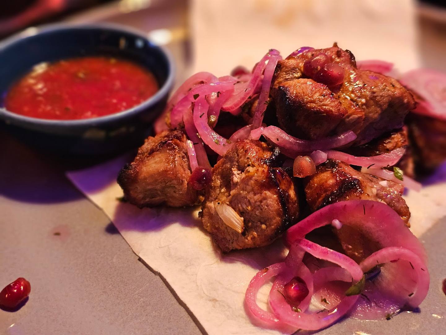 Crispy fried meat with pickled onions and dipping sauce