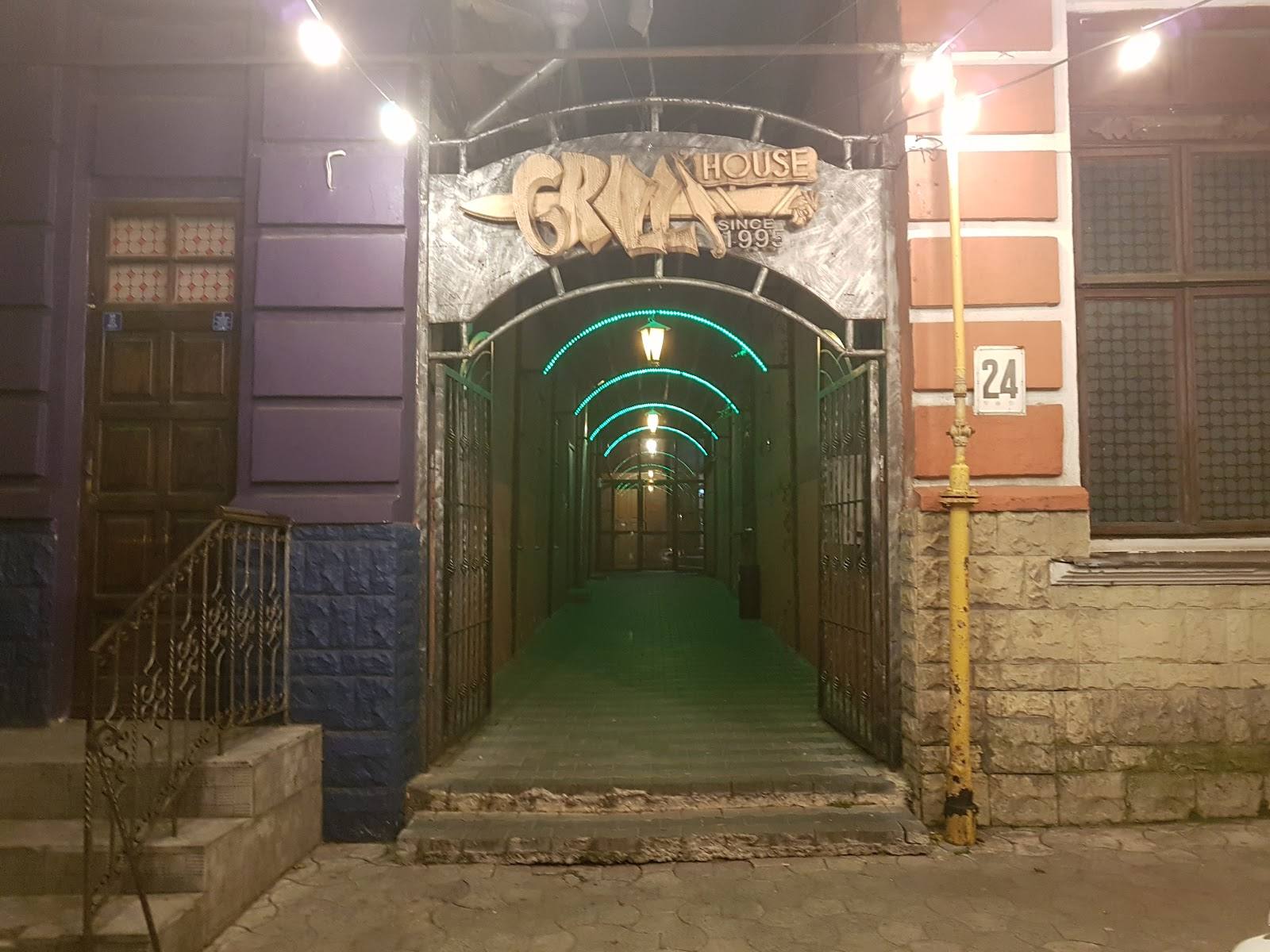 Entrance to SKAZ nightclub venue with lit green corridor and street-level signage