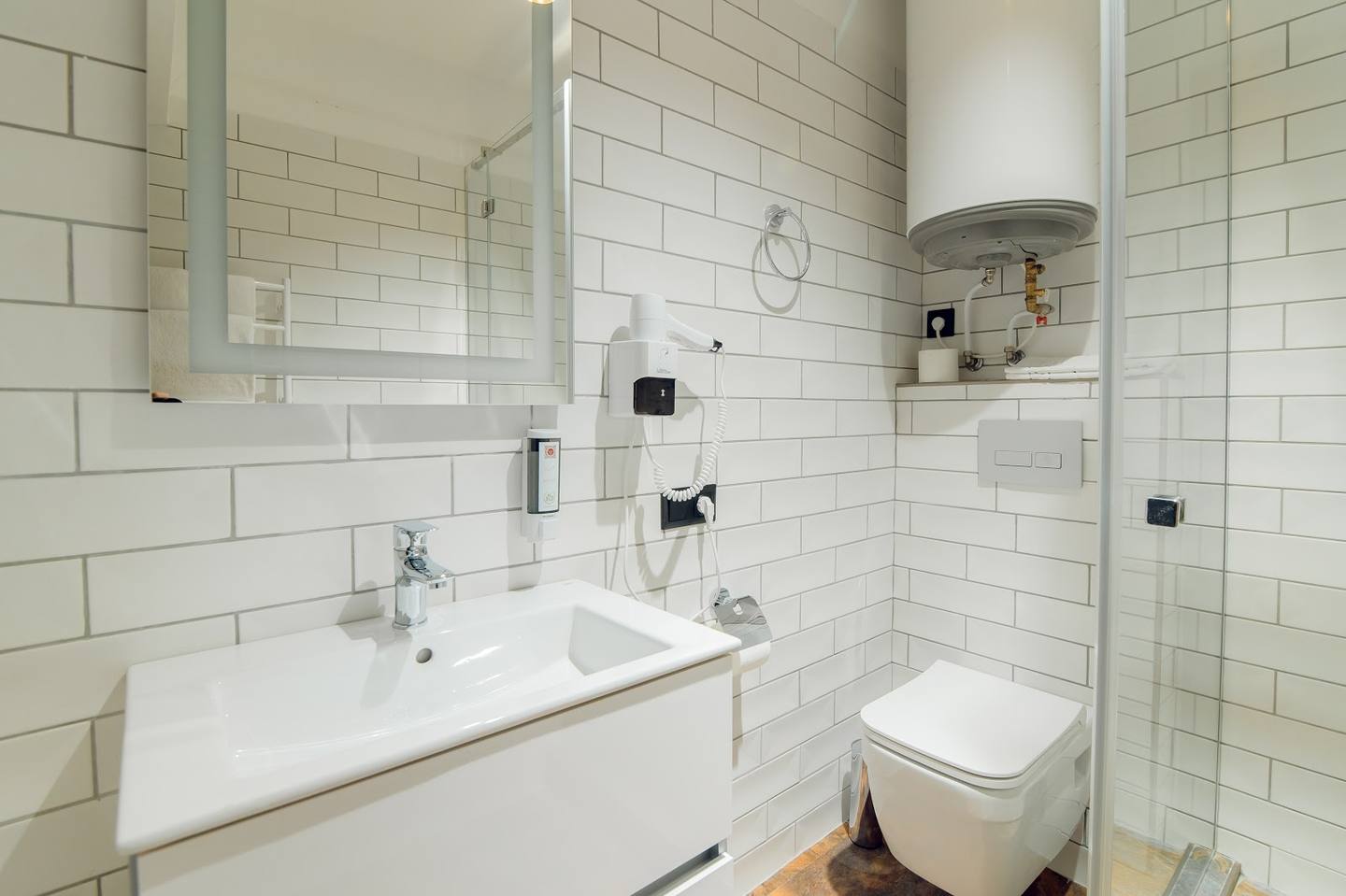 Modern bathroom with white subway tile walls and minimalist fixtures