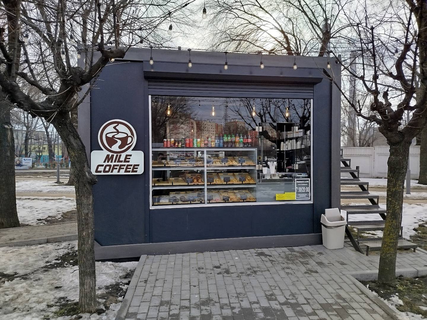 Nile Coffee kiosk with branded storefront and large display window in urban park setting