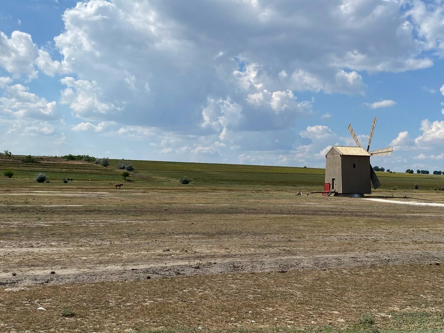 Small wooden chapel in open Moldovan steppe landscape