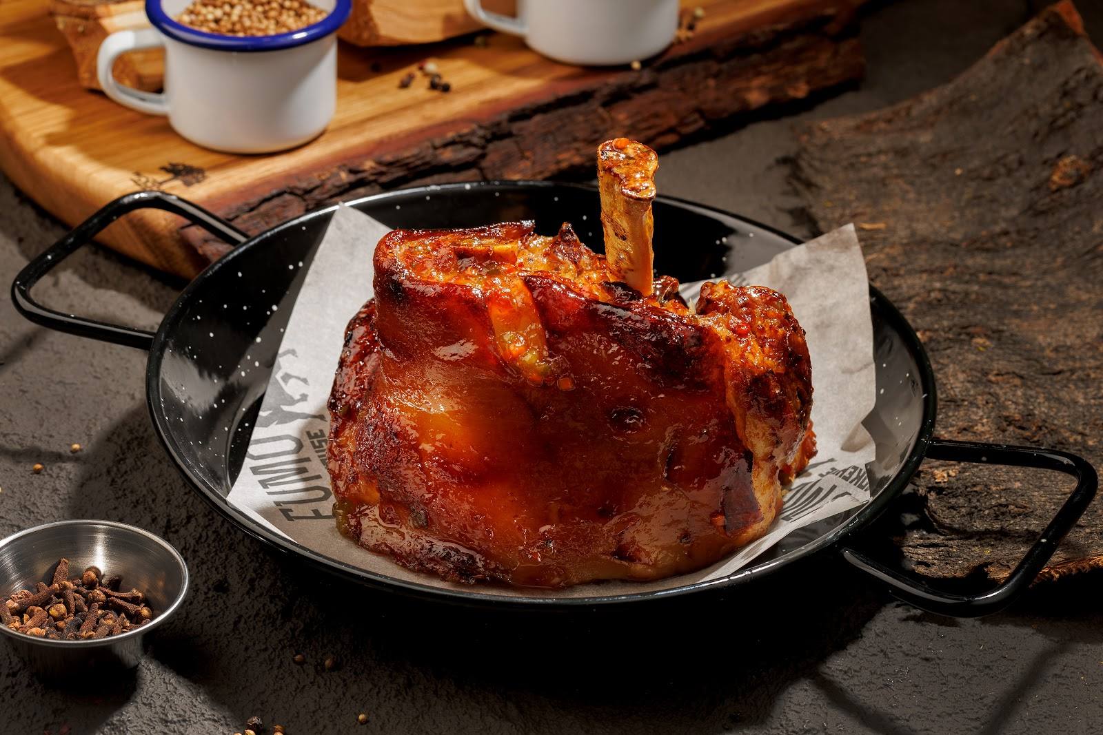 Roasted whole chicken in cast iron skillet with rustic tableware