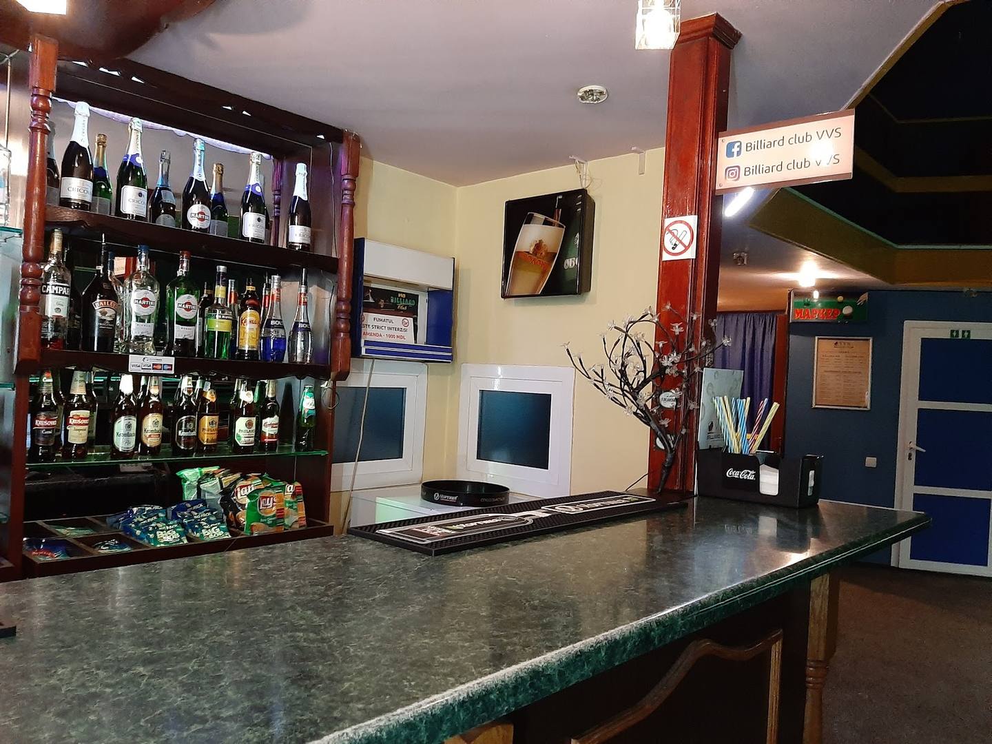 Wine bar counter with extensive bottle display and bar seating