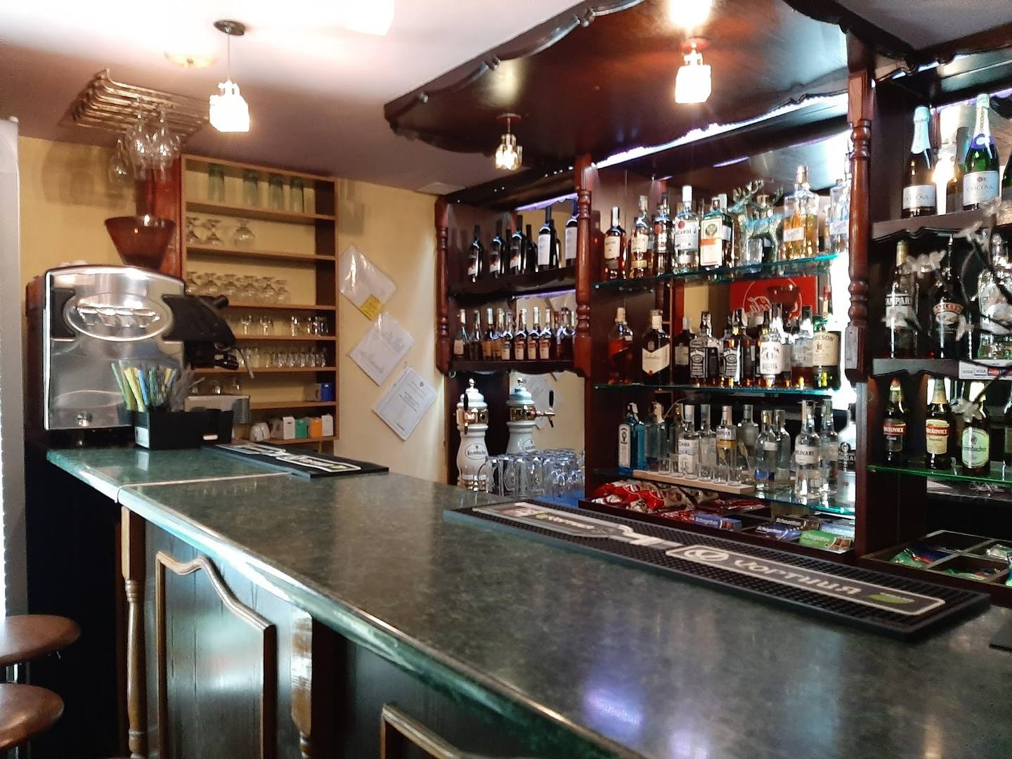 Well-stocked bar with extensive liquor display and professional counter setup