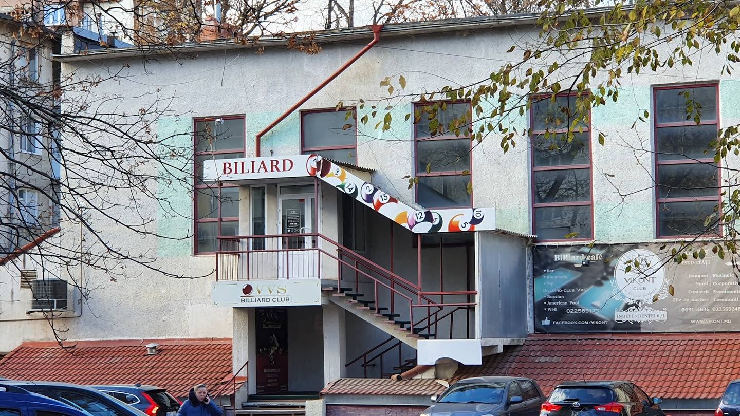 Billiard club storefront with signage and exterior staircase access