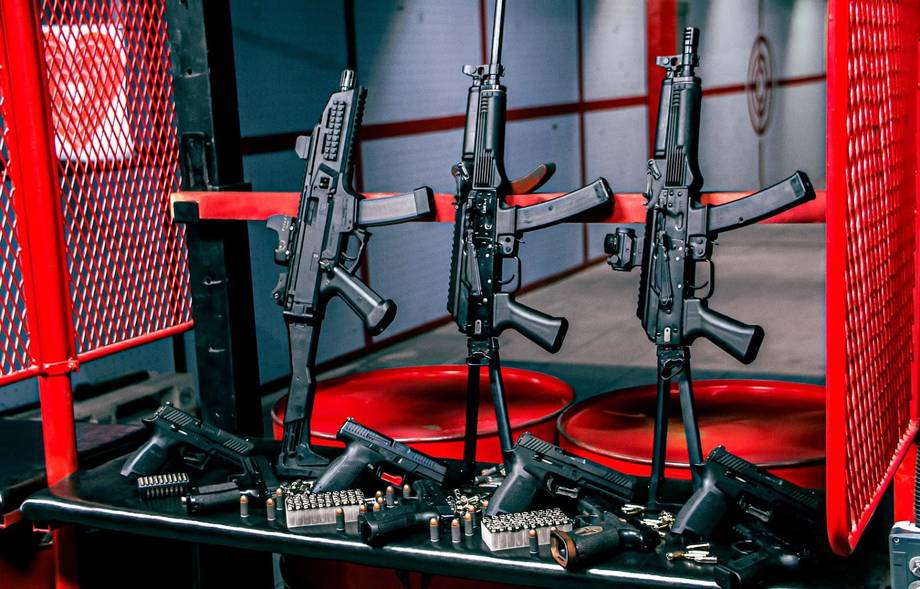Laser tag arena with three mounted rifles and red safety barriers