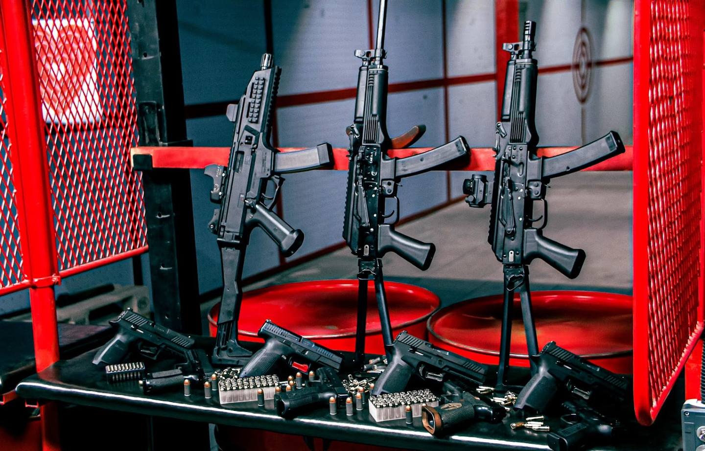 Laser tag arena with three mounted rifles and red safety barriers