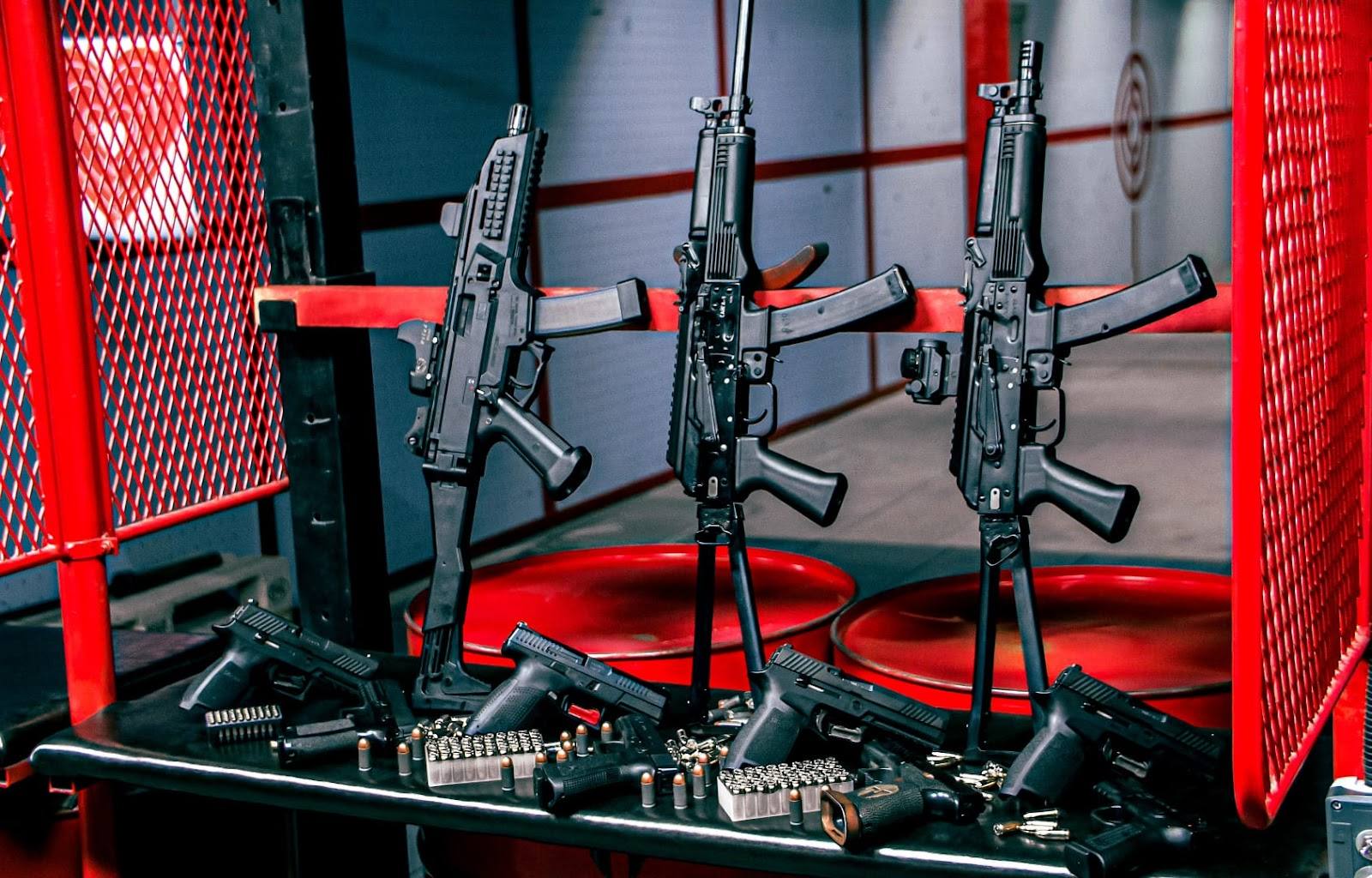 Laser tag arena with three mounted rifles and red safety barriers