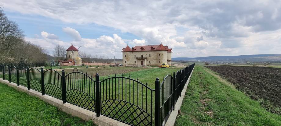 Historic Moldovan fortress estate with manicured grounds and surrounding countryside landscape
