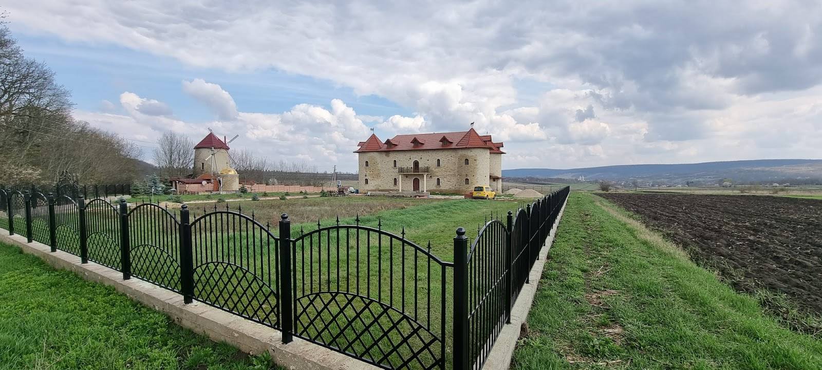 Historic Moldovan fortress estate with manicured grounds and surrounding countryside landscape