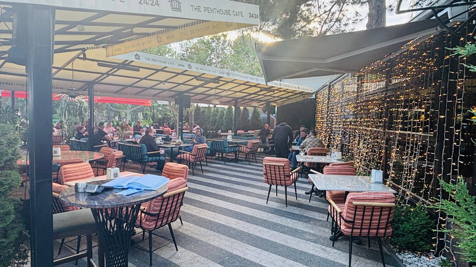 Outdoor terrace with striped paving, modern pergola, and dining area with orange cushioned seating