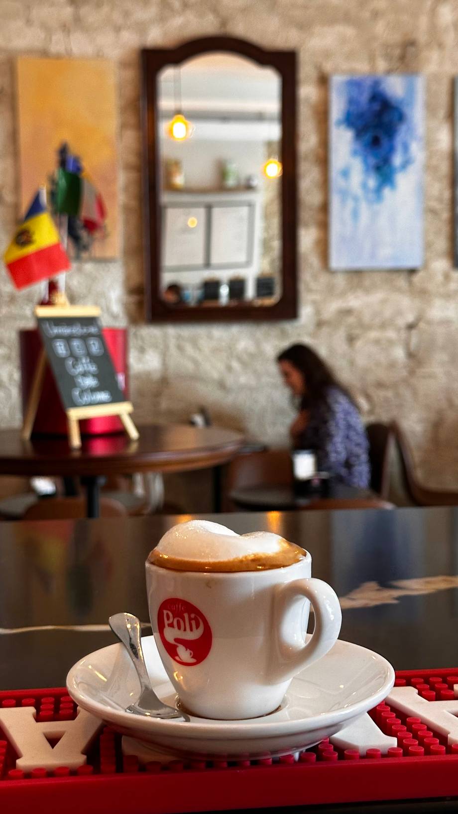 Cappuccino with branded cup at Polli cafe