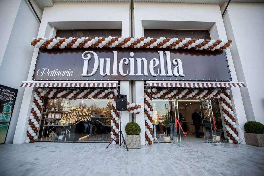 Dulcinella patisserie storefront with festive striped awning and holiday décor