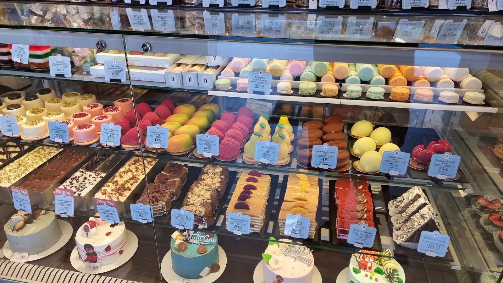 Colorful pastry and cake display case at bakery counter