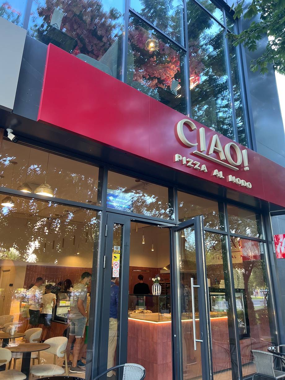 CIAO! pizza restaurant storefront with red signage and modern glass facade