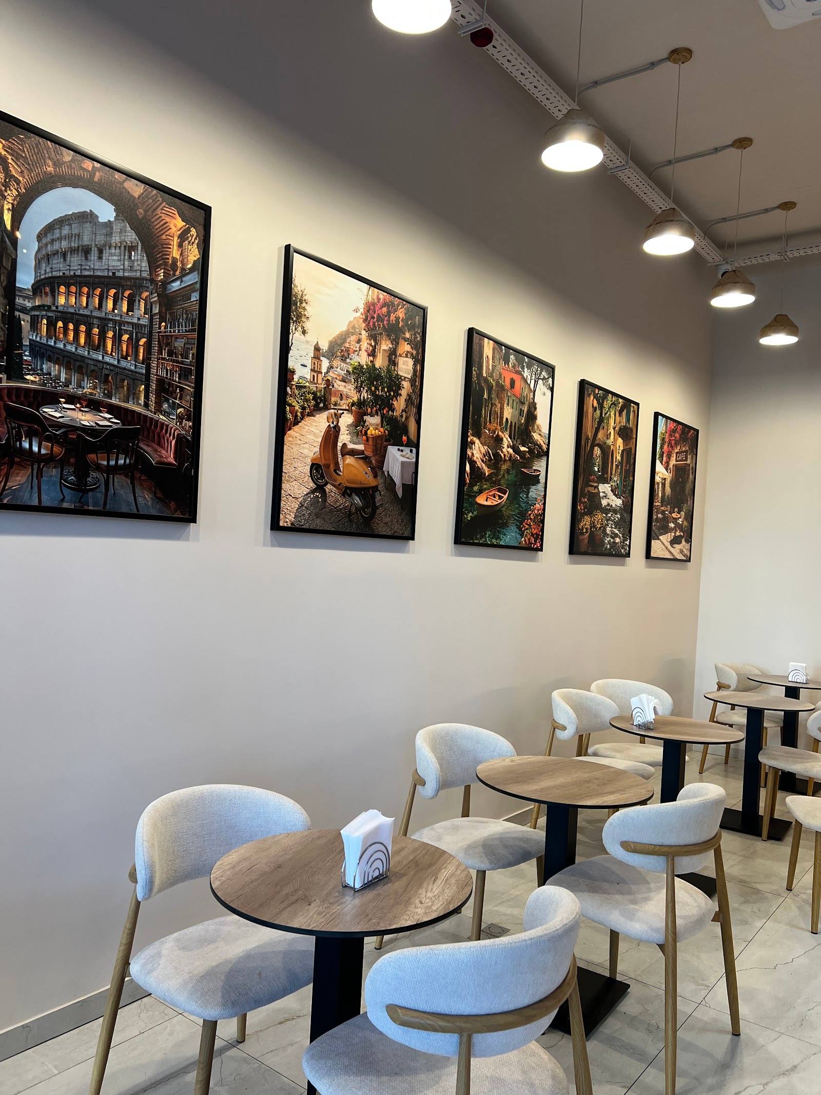 Modern cafe interior with curated wall art, round tables, and contemporary seating