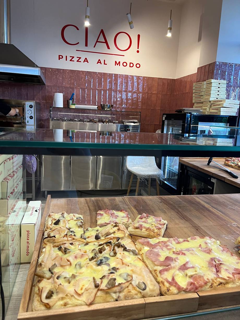 Pizza display counter at CIAOI pizzeria showing sliced al forno pizzas
