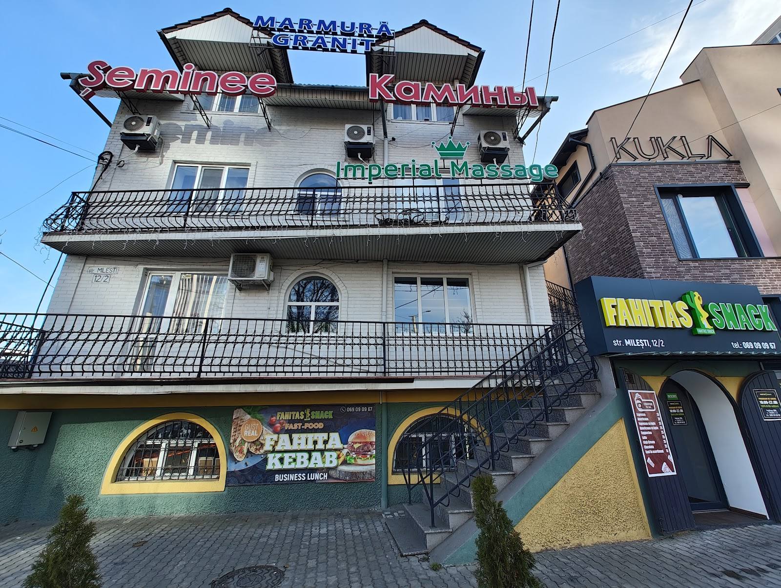 Multi-story venue building with prominent signage and ground-level restaurant entrances