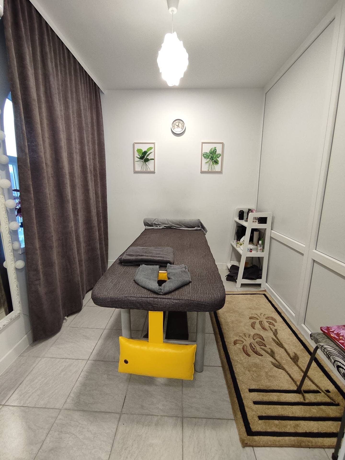 Massage treatment room with professional table and ambient lighting