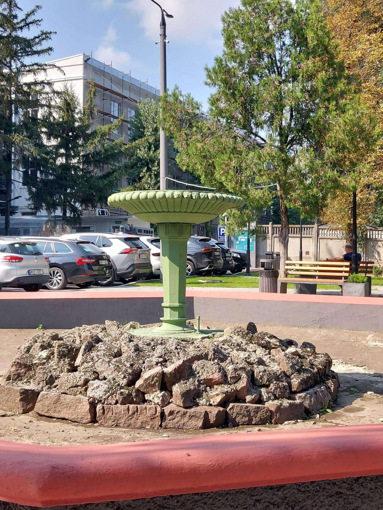 Public park sculpture and monument with green sculptural element