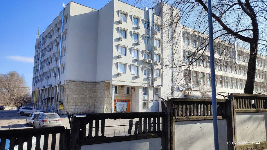 Soviet-era residential building with courtyard entrance and metal gates
