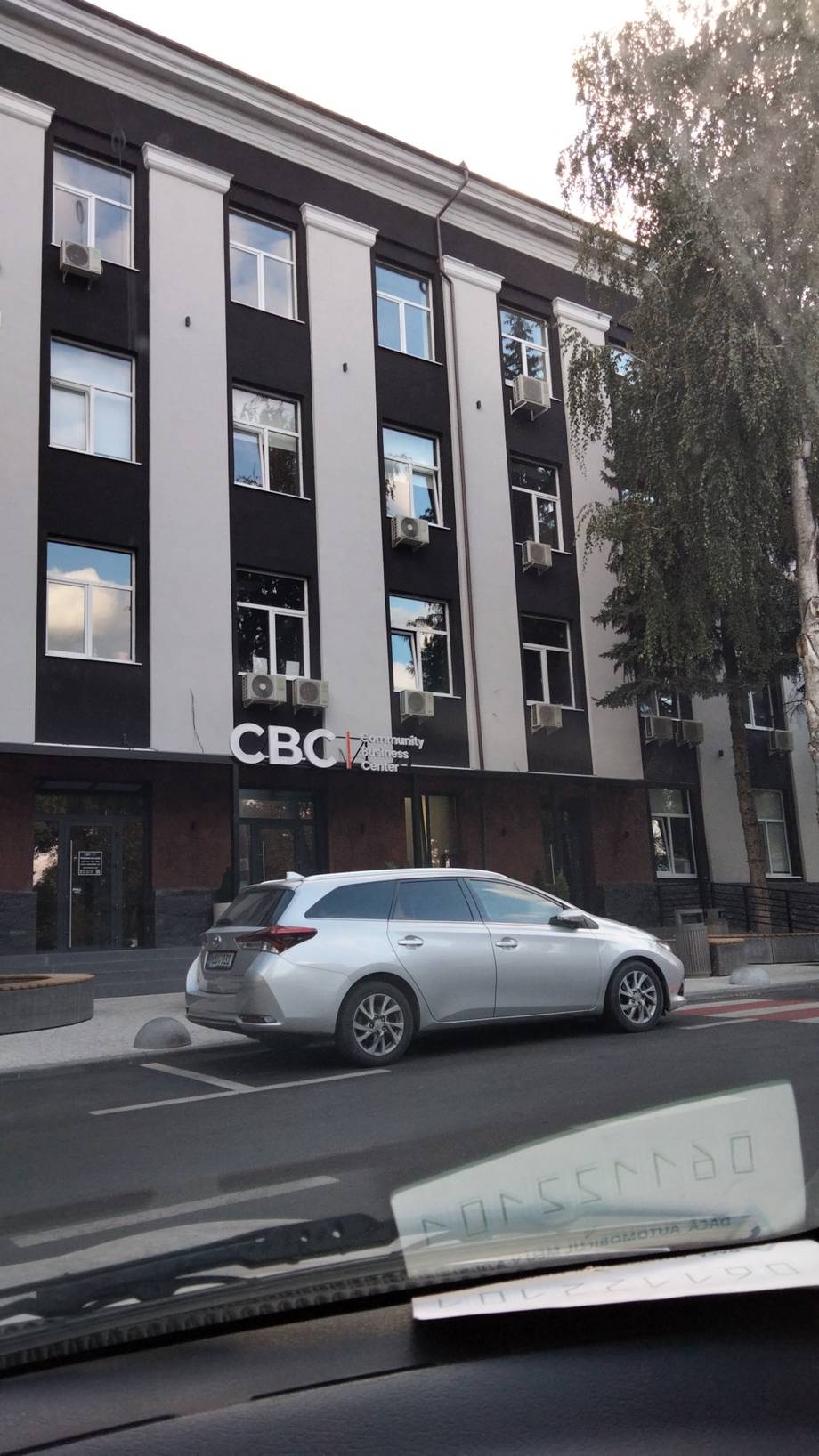 Modern storefront building with CBO signage and contemporary black-and-white facade