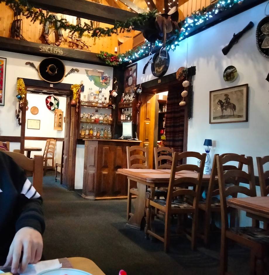 Rustic interior with wooden tables, traditional décor, and vintage wall ornaments