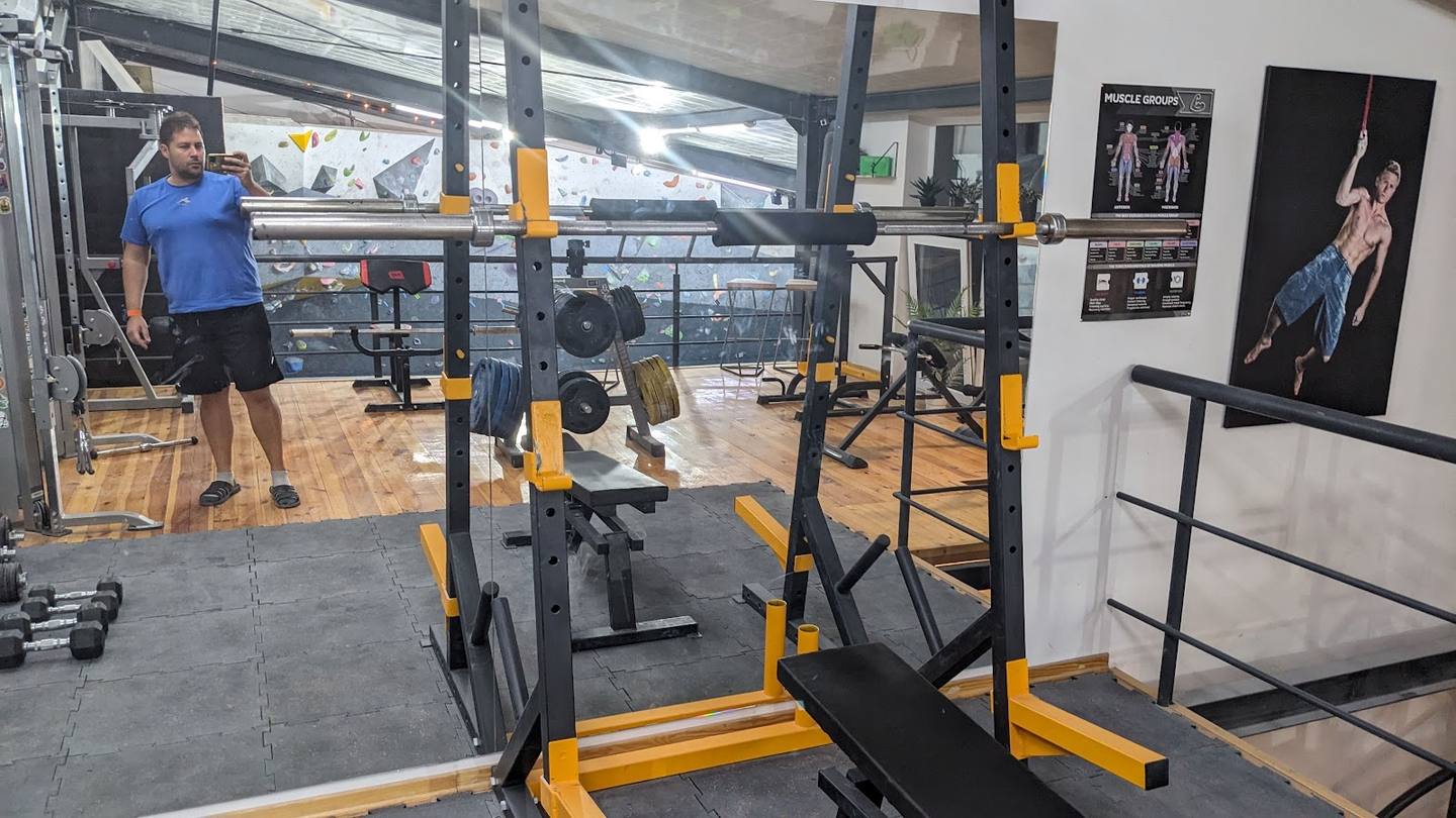 Functional fitness gym interior with yellow training rigs and equipment