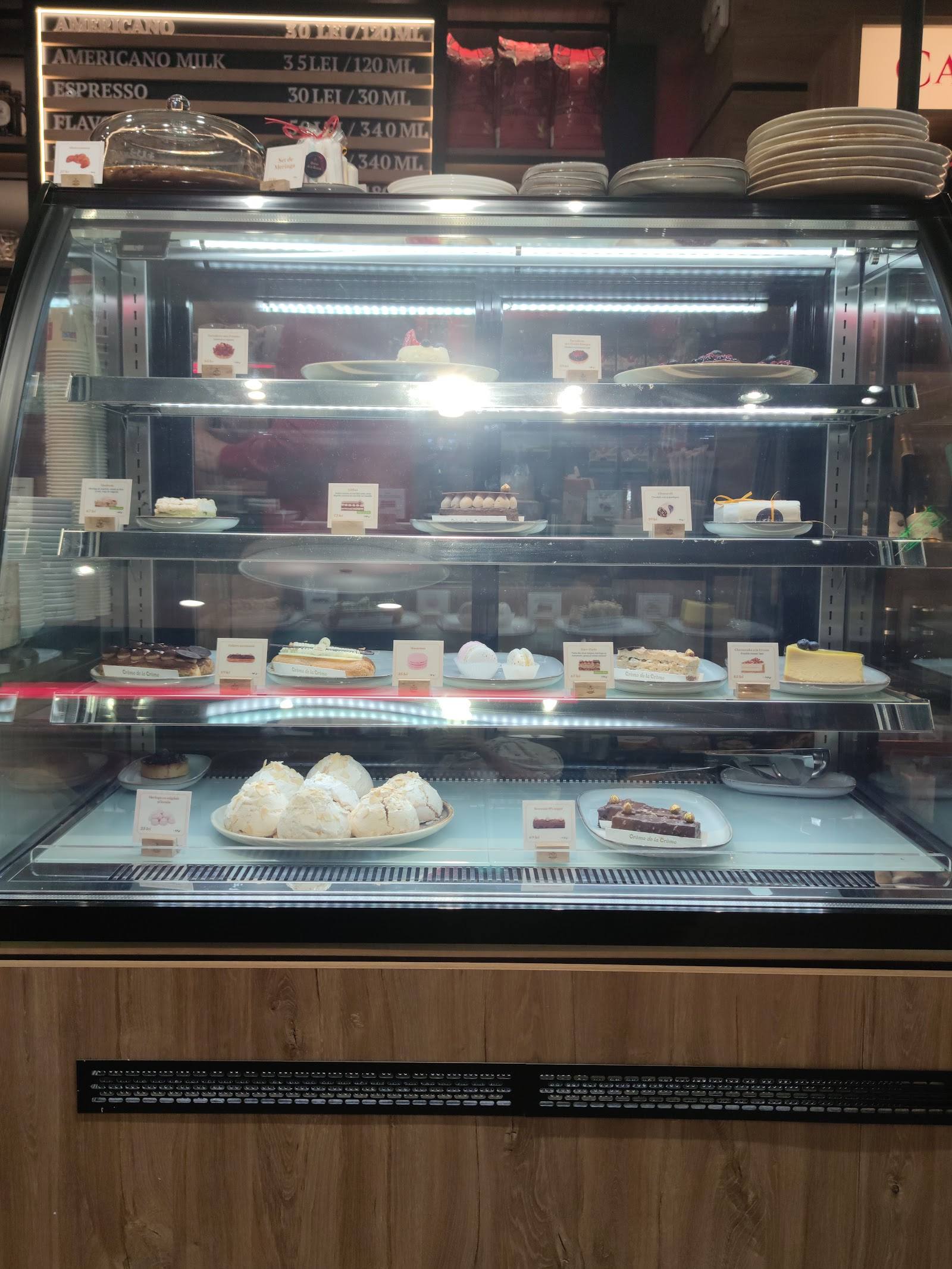 Refrigerated bakery and pastry display case with multiple shelves of assorted baked goods and desserts