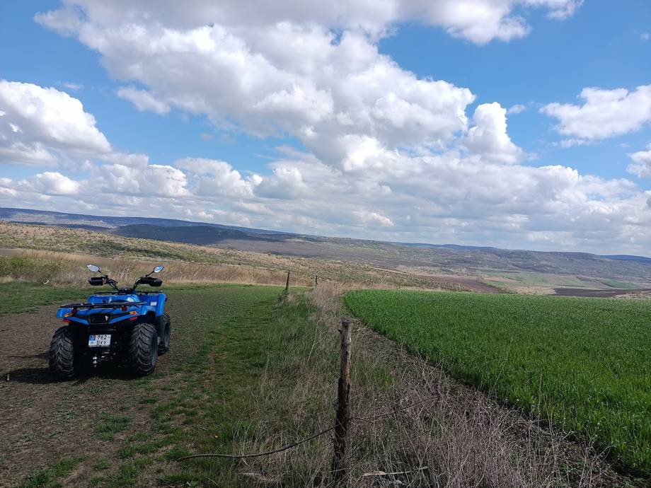 ATV adventure tour across rolling grassland with wide valley views