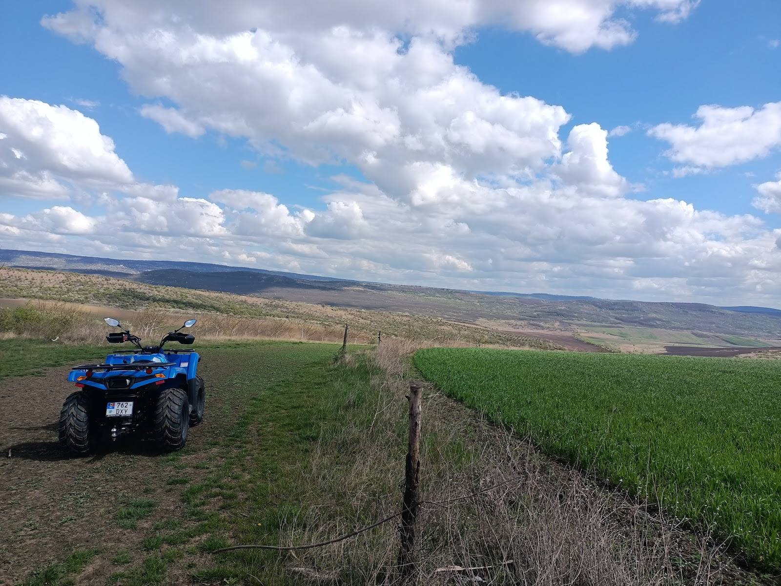 ATV adventure tour across rolling grassland with wide valley views