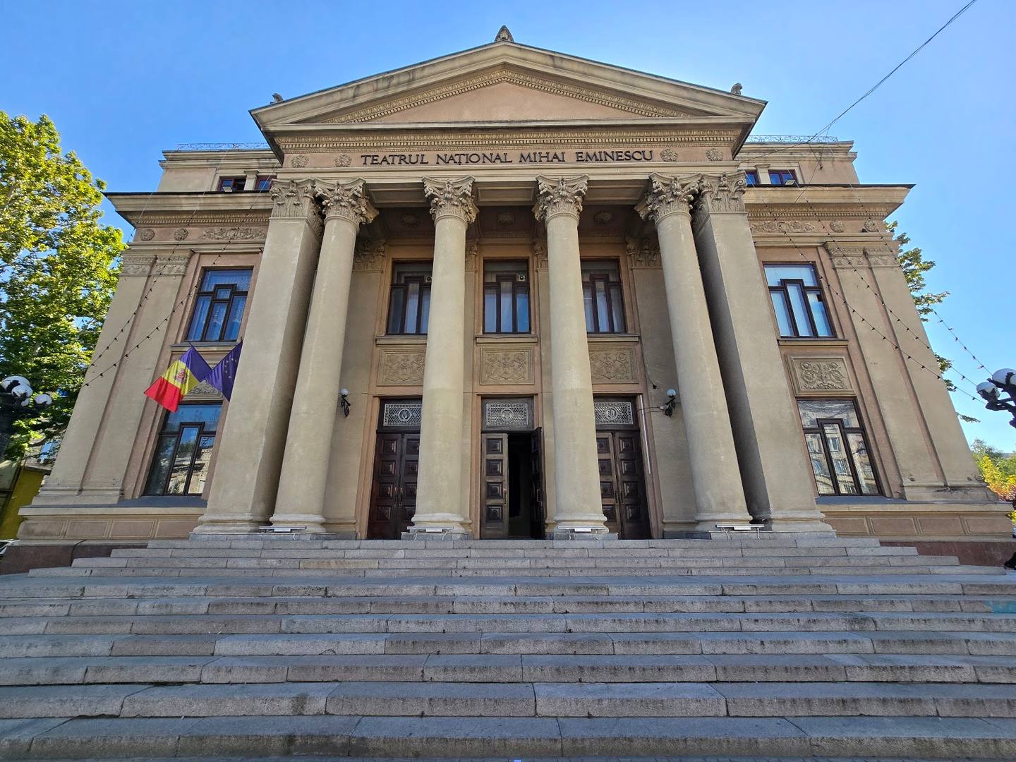 Neoclassical stone facade with grand columns and pediment, Moldovan historic building