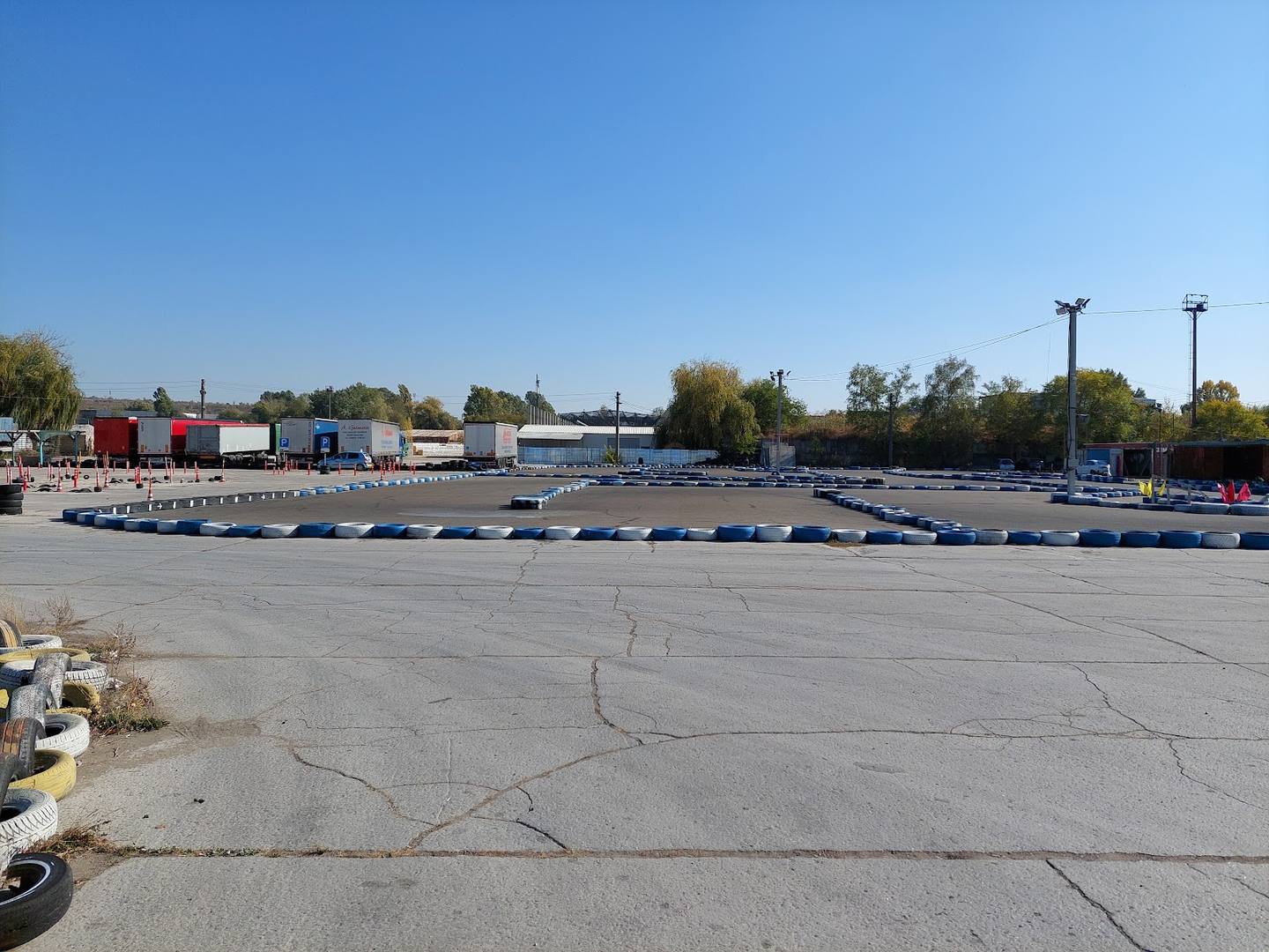 Go-kart racing track with marked lanes and spectator areas at outdoor venue