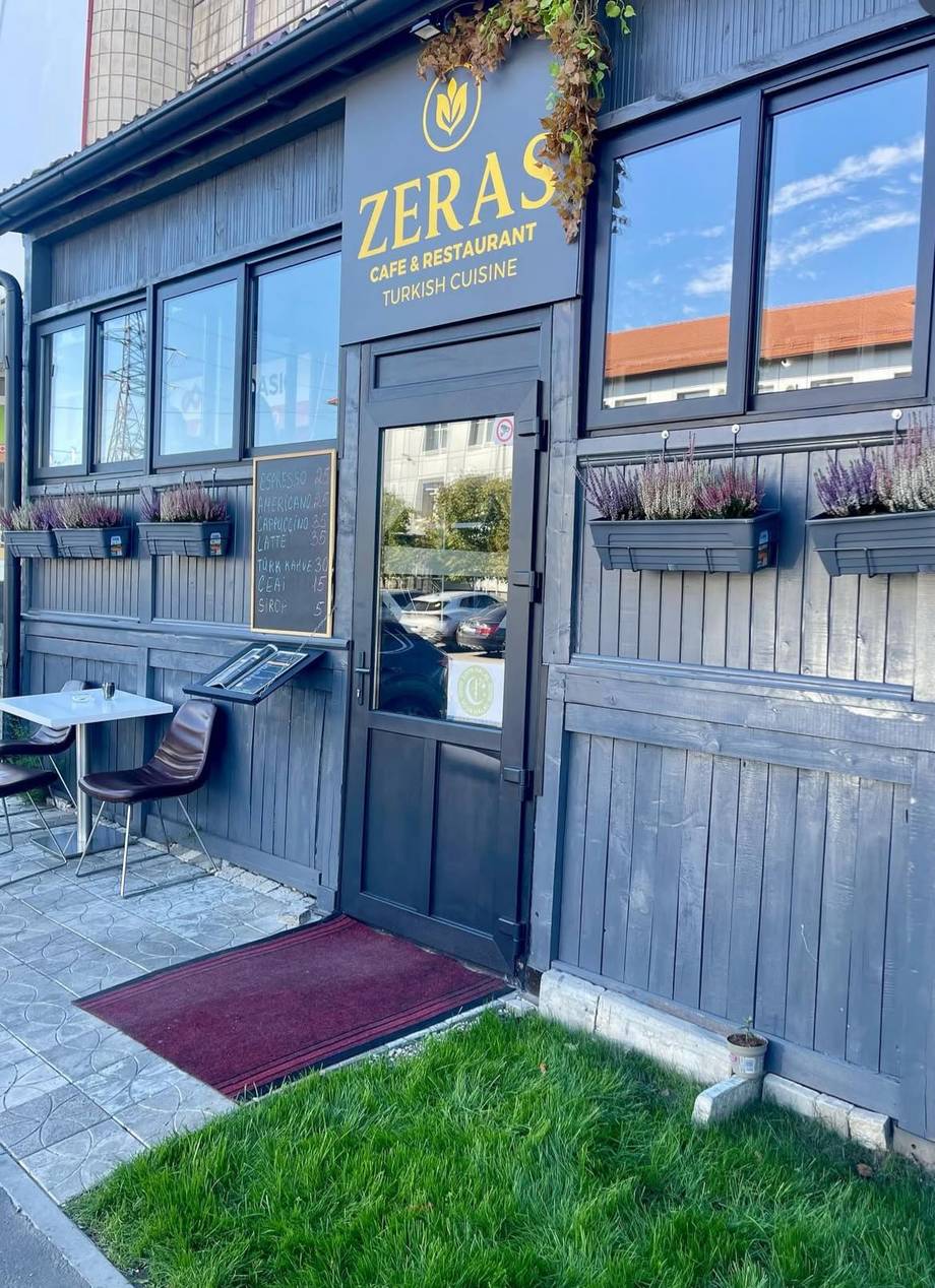 ZERÁS café & restaurant storefront with blue-grey wood facade and entrance