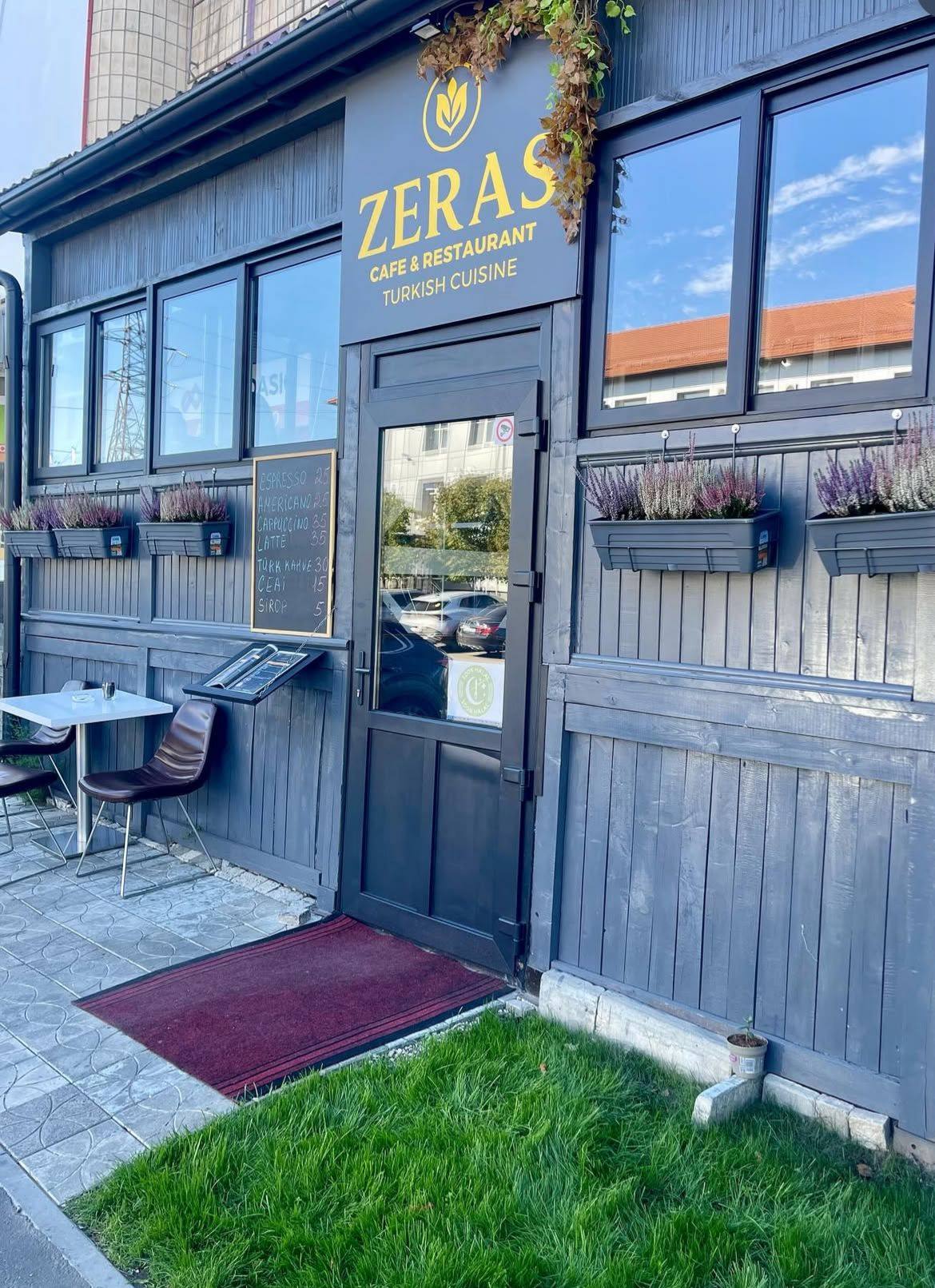 ZERÁS café & restaurant storefront with blue-grey wood facade and entrance