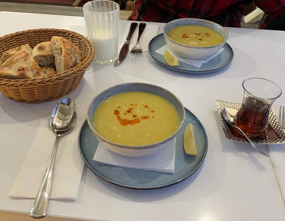 Table setting with soup course and bread service at a fine dining restaurant