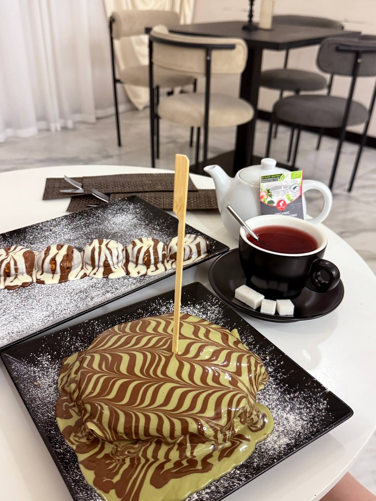 Artfully plated desserts with tea service in a modern dining space