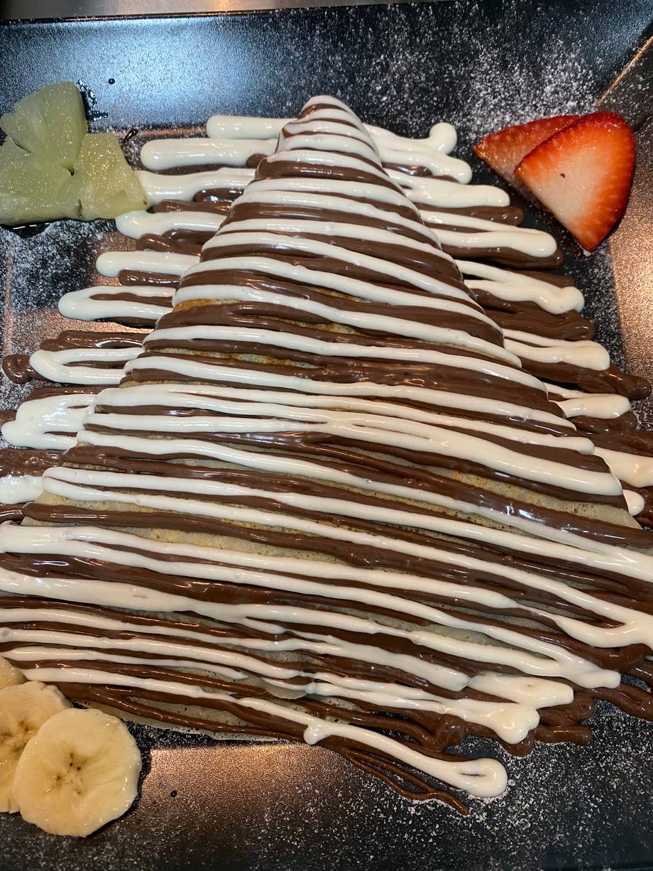 Chocolate dessert with striped pattern and fresh fruit garnish